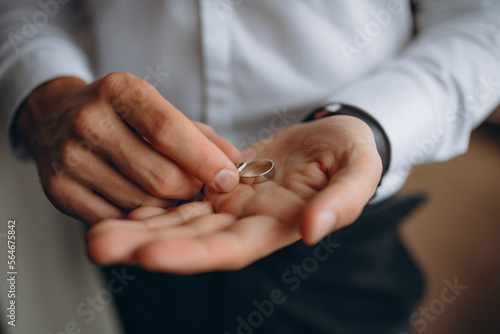 Man holding two wedding rings in his hands
