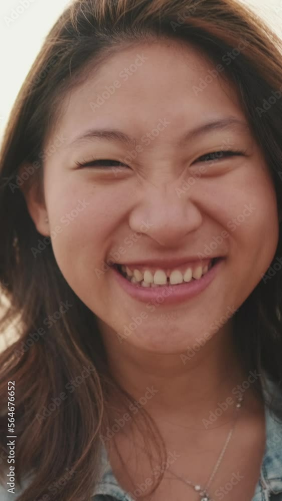VERTICAL VIDEO: Close-up of laughing beautiful young woman VERTICAL VIDEO: Close-up of laughing beautiful young woman
