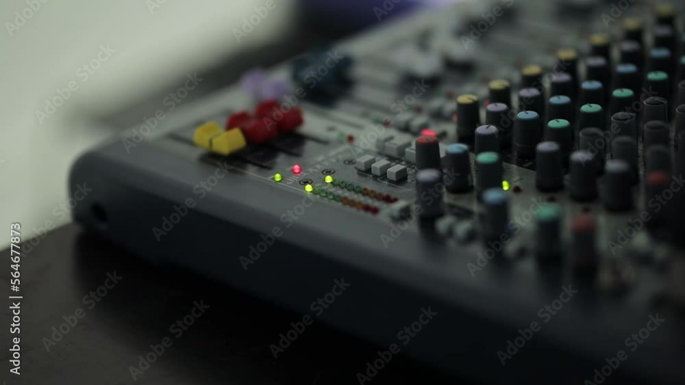 sound engineer console close-up. Electric machine on the table for the work of a sound designer or club dj at a nightclub party. Professional tool sound engineer in the studio or at a concert. sound engineer console close-up. Electric machine on the table for the work of a sound designer or club dj at a nightclub party. Professional tool sound engineer in the studio or at a concert.