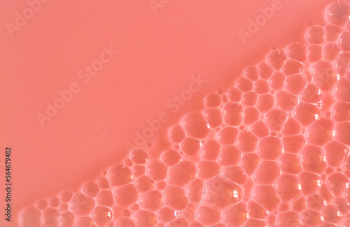 Bubble pink peachy background texture. Berry gel to cleanse the skin of the face and body. Spa treatments, skin care. Bath foam, detergent. Slime pink coral. photo