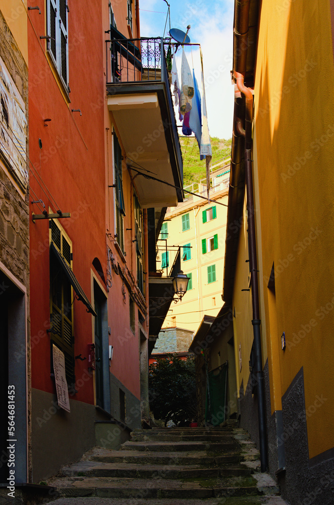 Fototapeta premium A narrow pedestrian street with steps in Vernazza. The Cinque Terre. Italy. Famous touristic place and travel destination. UNESCO World Heritage Site