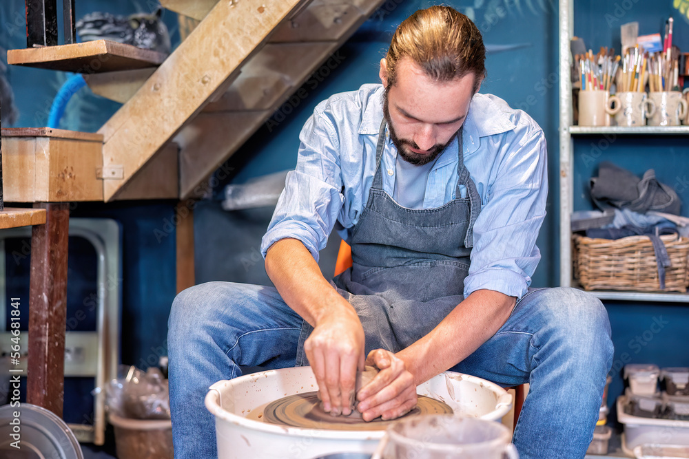 Man potter learning pot making ceramic clay objects on bench work in pottery workshop Man potter learning pot making ceramic clay objects on bench work in pottery workshop