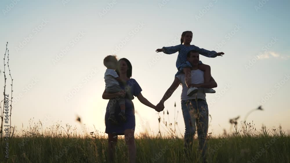 Silhouette of people in park. Happy family concept.Active walk in park at sunset. Happy family walk on green grass. Cheerful children with parents run outdoors in park. Silhouette of healthy people Silhouette of people in park. Happy family concept.Active walk in park at sunset. Happy family walk on green grass. Cheerful children with parents run outdoors in park. Silhouette of healthy people