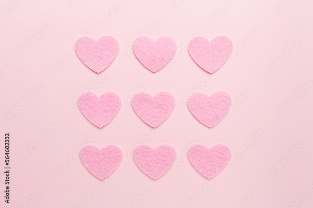 Felt hearts on color background, top view