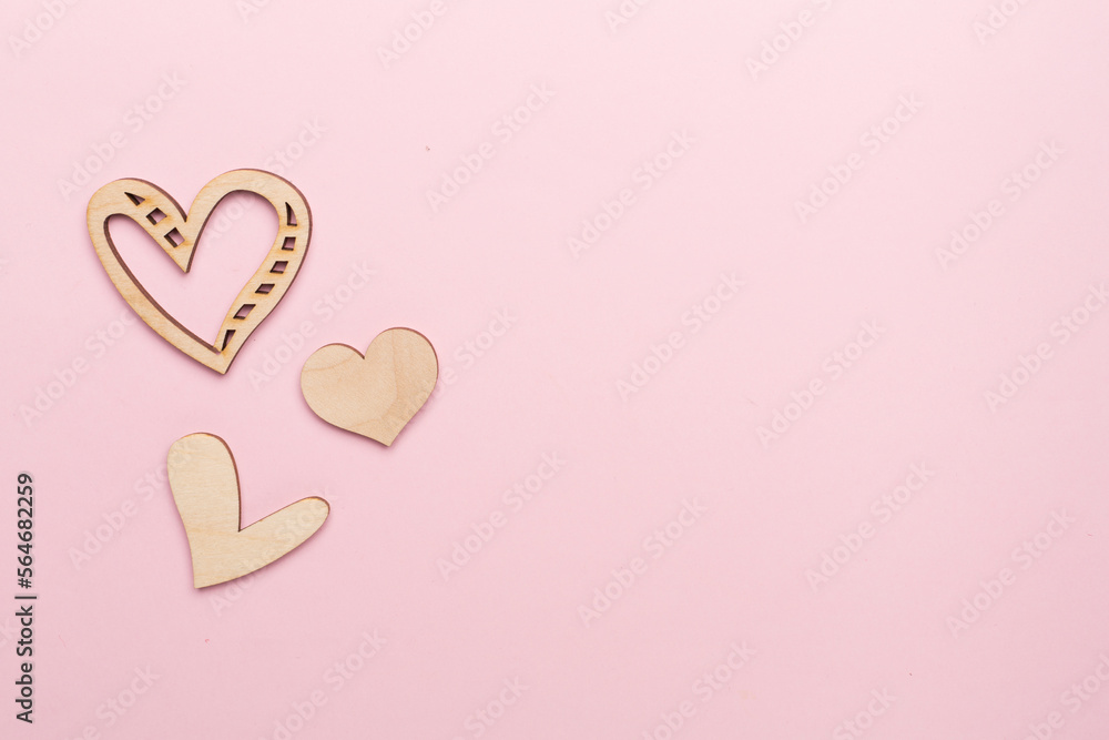Wooden hearts on color background, top view