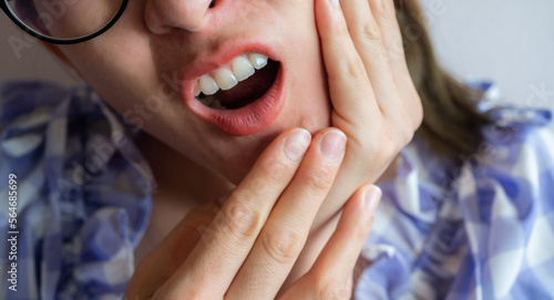 Cropped shot of Asian woman having suffering from toothache. Toothaches can be caused by something happening to your teeth or gums.