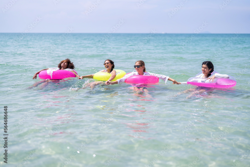 Teenage girl friendship enjoy laughing play on sea swimming with water inflation toy on blue sky day Teenage girl friendship enjoy laughing play on sea swimming with water inflation toy on blue sky day