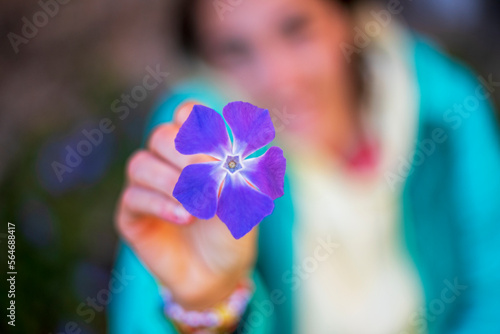 Girl holds a flower with defocused background