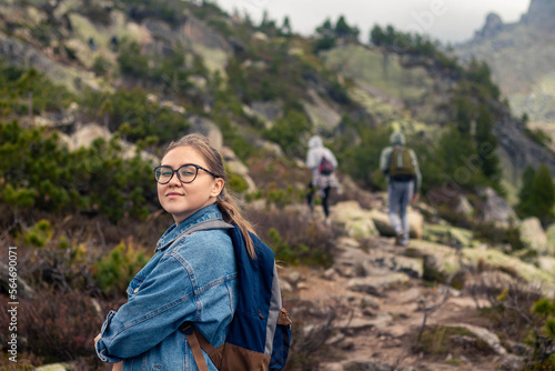 young woman is hiking with friends on mountain © Roman