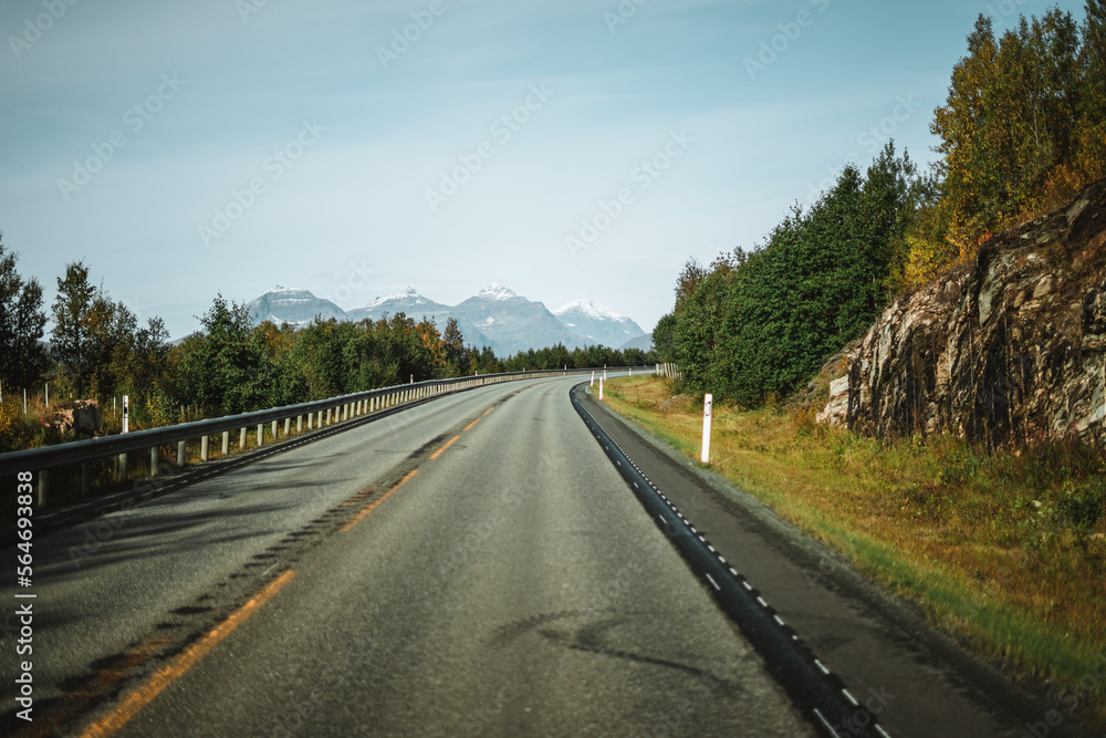 Empty road with a view on majestic mountains and the norwegian landscape in autumn