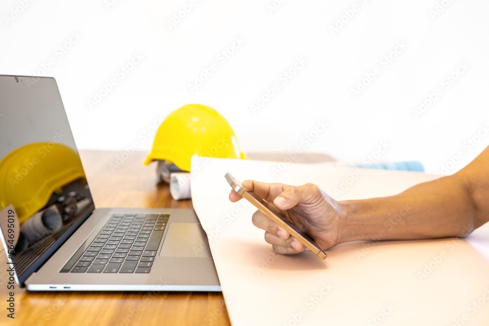Engineer's hands working on the laptop and mobile phone. Business man using mobile phone and laptop at workplace..Working on laptop computer, using mobile phone, office business..