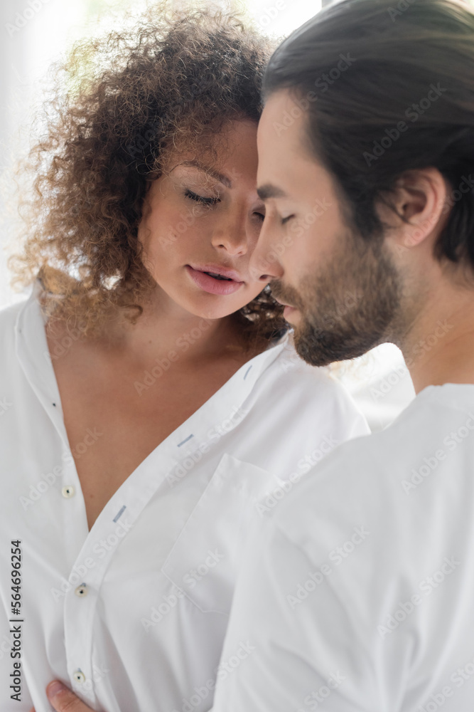 bearded man with closed eyes near sensual girlfriend in white shirt. bearded man with closed eyes near sensual girlfriend in white shirt.