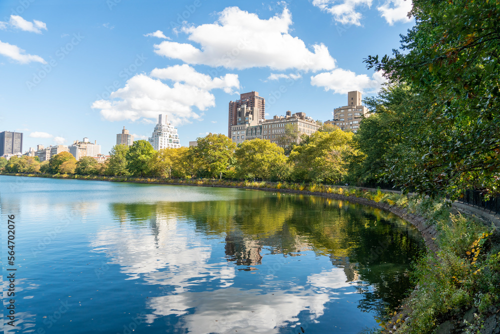 City view with Central Park, view of the sea, sky silhouette with clouds reflected in the water, New York.