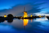 Kinderdijk National Park in the Netherlands. Windmills at dusk. A natural landscape in a historic location. Reflections on the water surface. Dutch canals. UNESCO World Heritage Site.