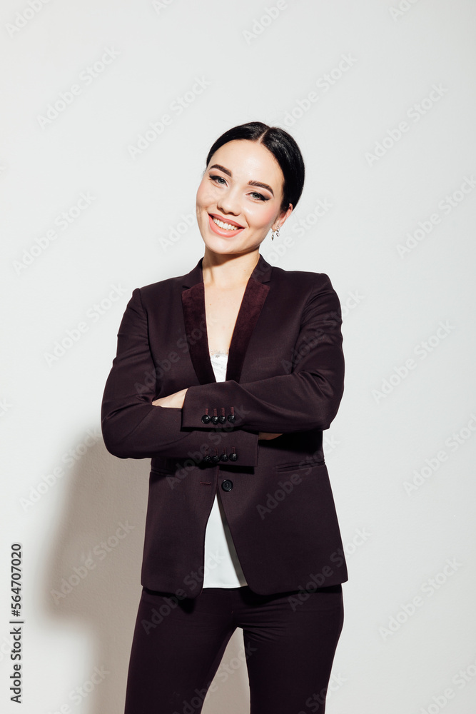 business woman at work in the office stands in a business suit business woman at work in the office stands in a business suit