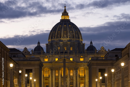 View of Saint Peter Basilica in the Vatican, the church of the Pope, from Via della Conciliazione at night with lights. Vatican Rome Italy Europe