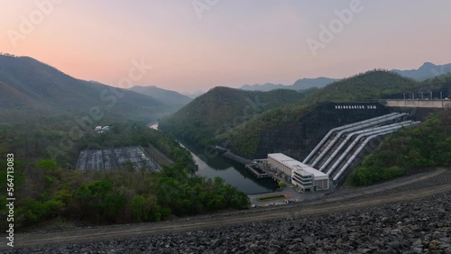 Sunrise over Srinagarind dam with power plant infrastructure for irrigation and agriculture in the valley at Kanchanaburi photo