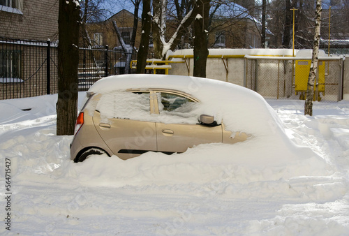 Winter landscape with car covered with snow