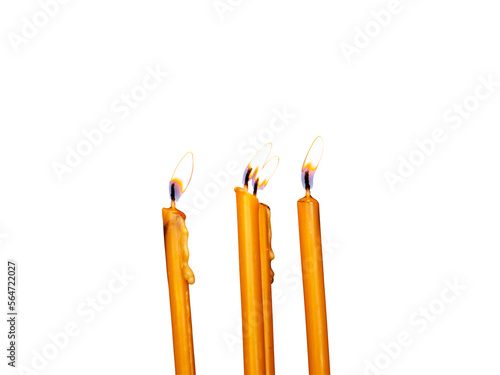 Four yellow burning wax candles with flame up isolated