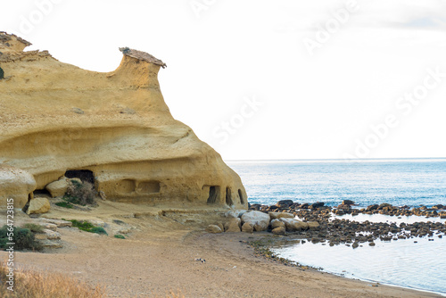 Small eroded mount on the beach of los cocedores in Pulpí, Spain photo