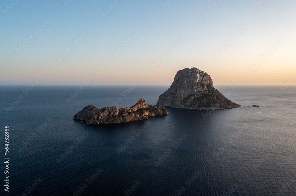 Es Vedra is an islet located on the island of Ibiza, calm blue sea and beautiful sky