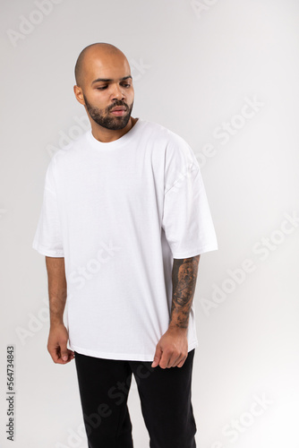Bald guy african american with a beard in a white blank t-shirt. Mock-up.