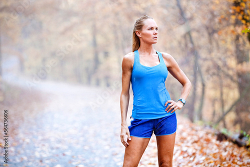 A woman rests after a road run in the rain at Oak Mountain State Park in Pelham, Alabama. photo