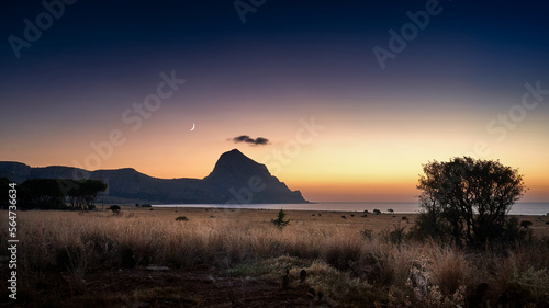 Mountain above the sea at sunset in the Sicilian landscape