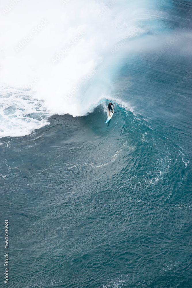 An aerial view of a young man surfing a big wave at Pipeline, on the north shore of Oahu, Hawaii. An aerial view of a young man surfing a big wave at Pipeline, on the north shore of Oahu, Hawaii.