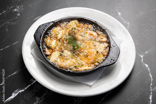 dish of steaming garlic shrimps, typical spanish dish.
