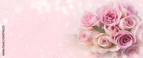 Bouquet of pink roses flowers on pastel pink bokeh background banner with hearts shape - Mother's Day, Valentine's Day, Wedding, Birthday and Happy Woman's Day. Panorama with copy space for your text