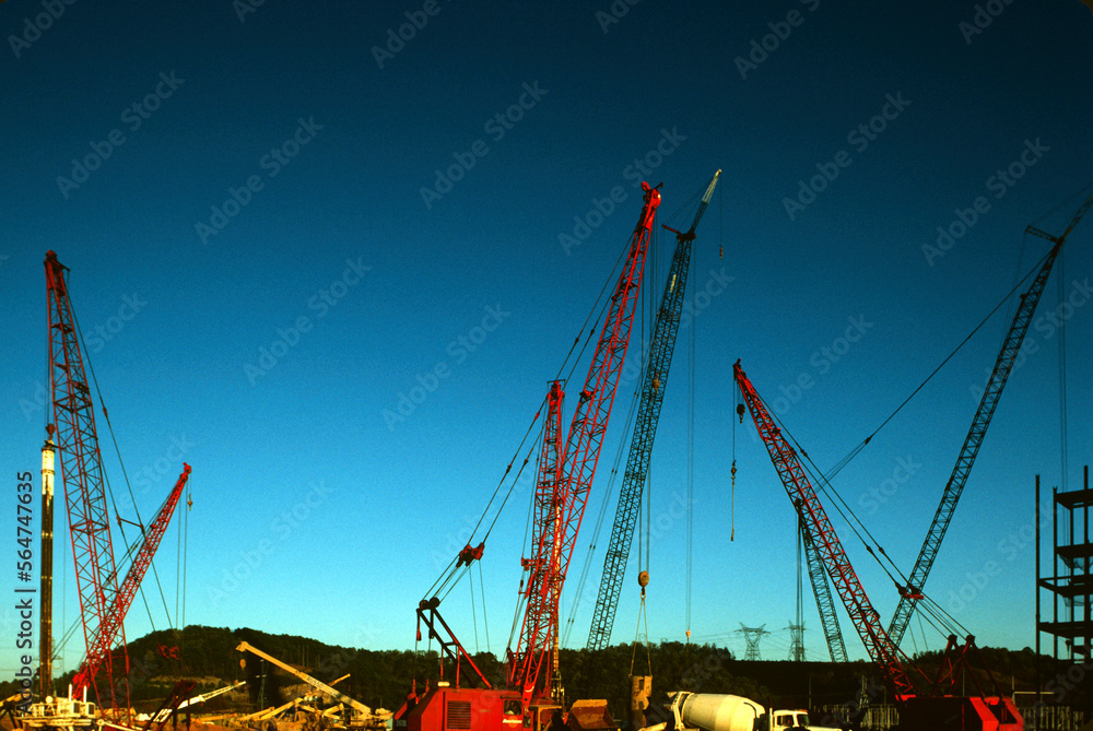 Cranes, cement trucks and other heavy duty equipment at commercial