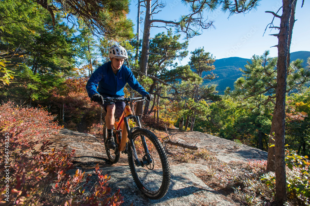 Mountain Biker Riding On The Bare Granite Slabs Of The Whitehorse Ledge, New Hampshire Mountain Biker Riding On The Bare Granite Slabs Of The Whitehorse Ledge, New Hampshire