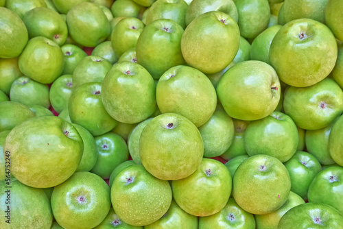 Bright green, fresh apples top view close-up. Natural, juicy background.