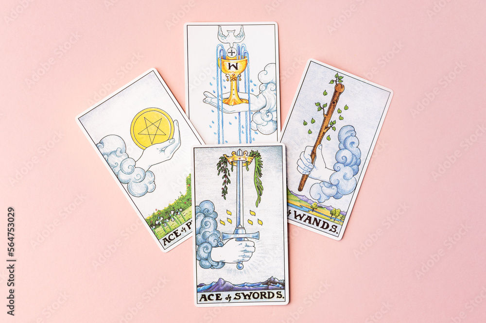 London, UK: 6 January, 2023: Minor Arcana - Ace of Cups, Ace of Wands, Ace  of Swords and Ace of Pentacles of Tarot Card of Rider Waite deck on pink  background Stock-Foto