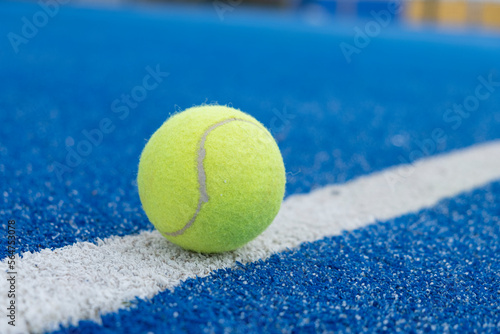 selective focus, close-up view of a ball on the line of a paddle tennis court. Racket sports concept © Vic