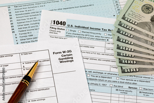 W-2G gambling income form for federal income tax return and cash money. Federal tax return, income tax and tax refund concept.