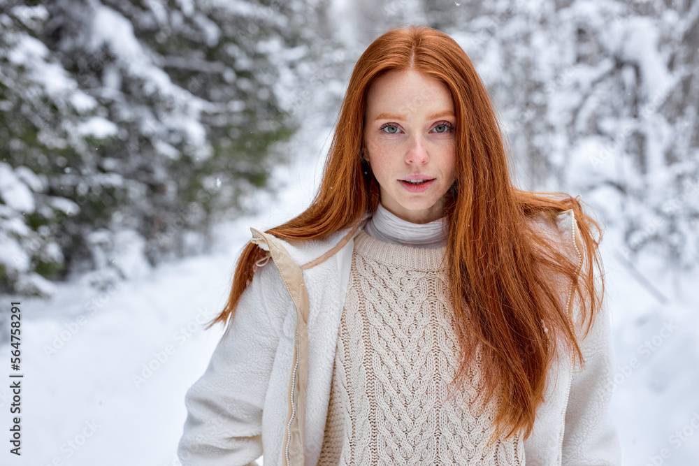 natural redhead female model posing at camera in winter forest, looking at camera, walking alone, dressed in white stylish coat. calm awesome lady with long red hair having wonderful look, glance natural redhead female model posing at camera in winter forest, looking at camera, walking alone, dressed in white stylish coat. calm awesome lady with long red hair having wonderful look, glance