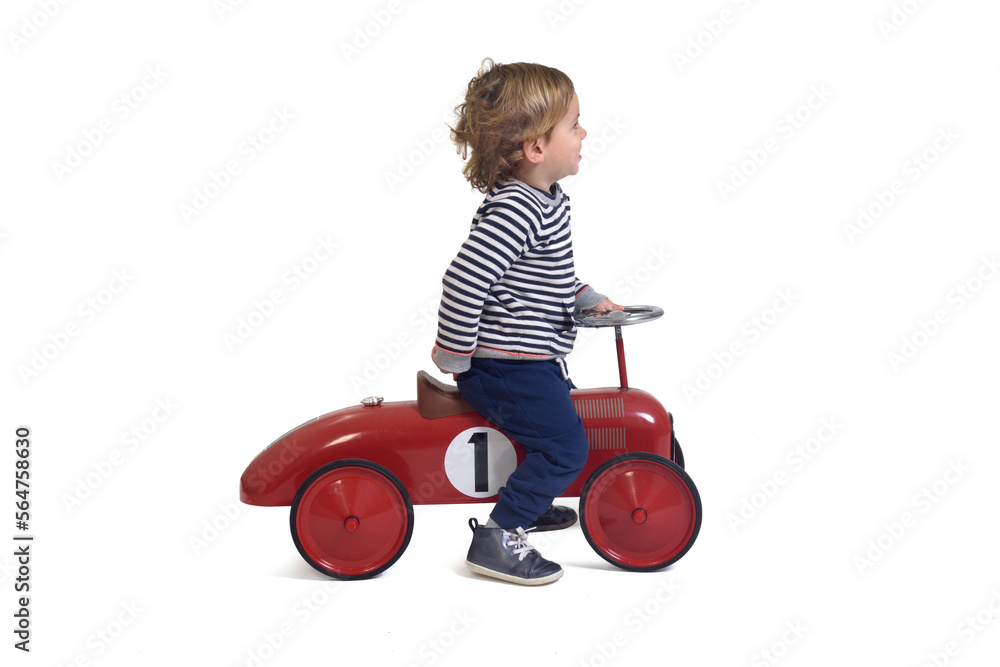 side view of a baby boy playing with car toy on white background side view of a baby boy playing with car toy on white background