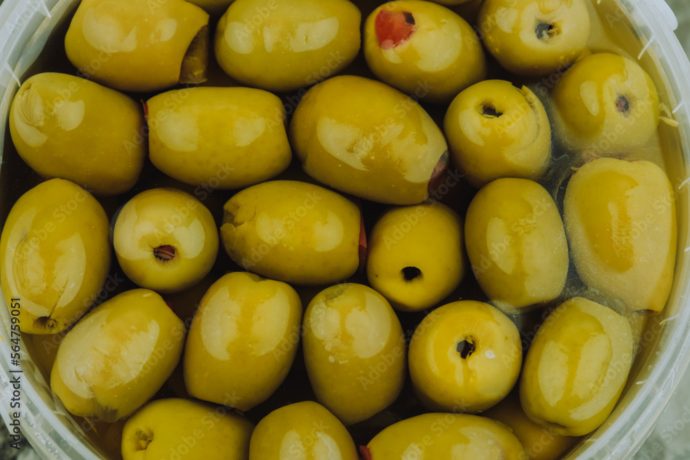 Green olives stuffed with peppers, pickled olives, macro photo from above. Food concept. Green olives stuffed with peppers, pickled olives, macro photo from above. Food concept.