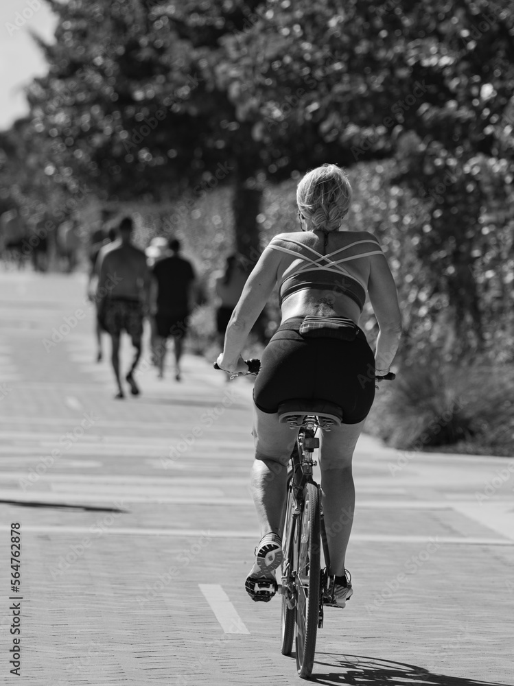 woman  riding a bike sport morning Miami Beach  