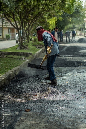 workers fixing potholes on the road