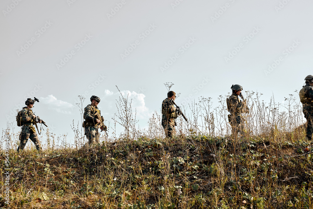 Armed forces, brave and strong soldiers with rifle going against