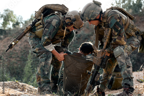 Konstfotografi friendly fearless special forces soldiers help injured comrade during the rescue operation