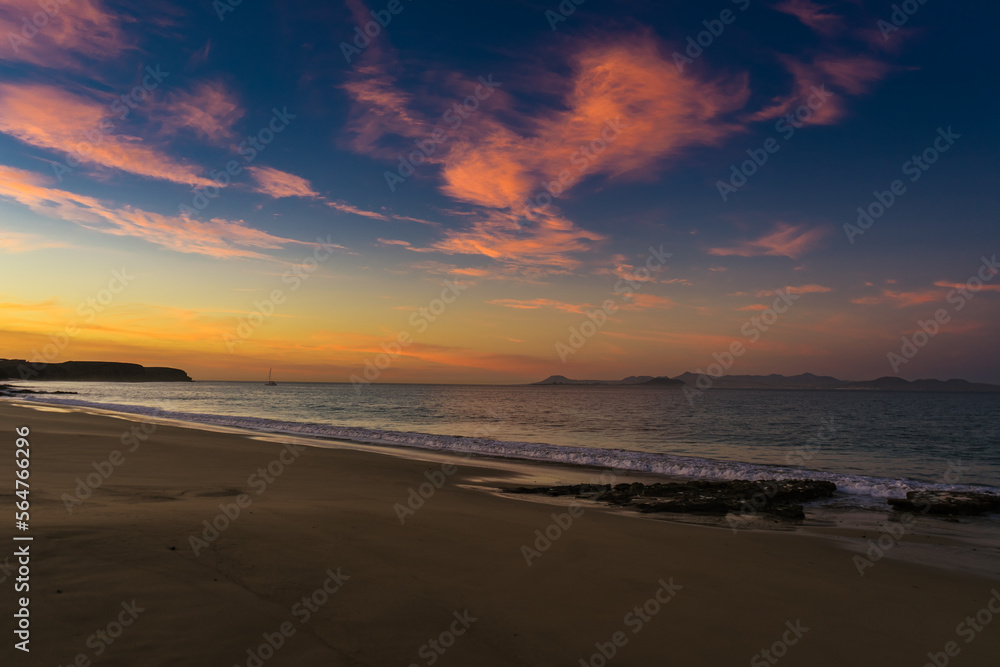 The colours of the sunrise reflected in the sky above one of Papagayo's beaches in Lanzarote The colours of the sunrise reflected in the sky above one of Papagayo's beaches in Lanzarote