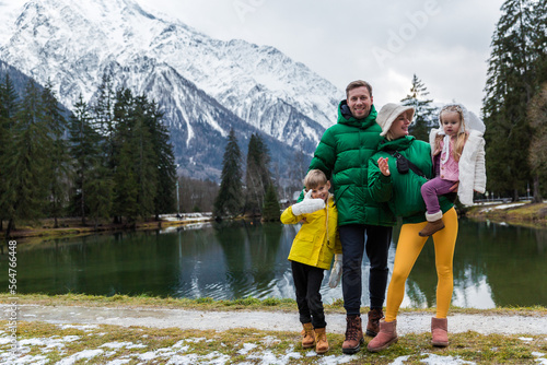 Family having the holiday at Gaillands lake in Chamonix, french alps.Clouses greenand yellow.