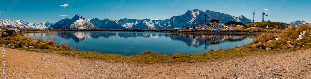 High resolution stitched panorama with reflections in a lake at the famous Penken summit, Zillertal valley, Mayrhofen, Tyrol, Austria