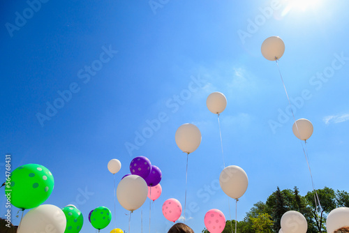 Fotografija Balloons released into the sky on a festive day.