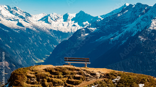 Beautiful alpine summer view with a wooden bench at the famous Penken summit, Mayrhofen, Tyrol, Austria