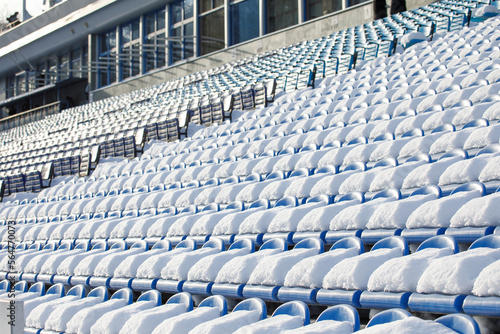  snow the seats of the stadium stands are covered with